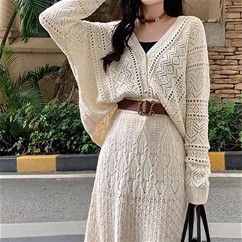 Beige two-piece set with hollowed-out knit top and mid-length lace-up skirt and belt