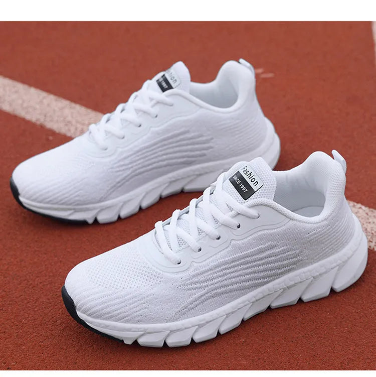 Women's low-top black and white running sneakers with cross-strap detail and MD sole.