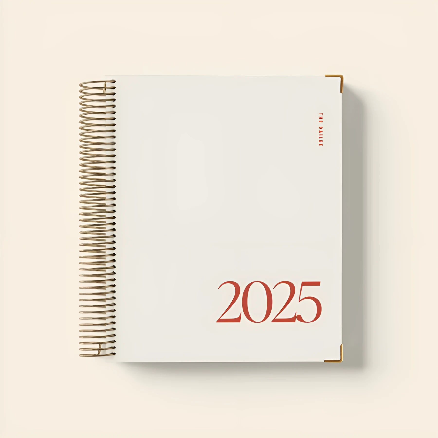 Cherry red A5 daily planner coil notebook open on a weekly view page.