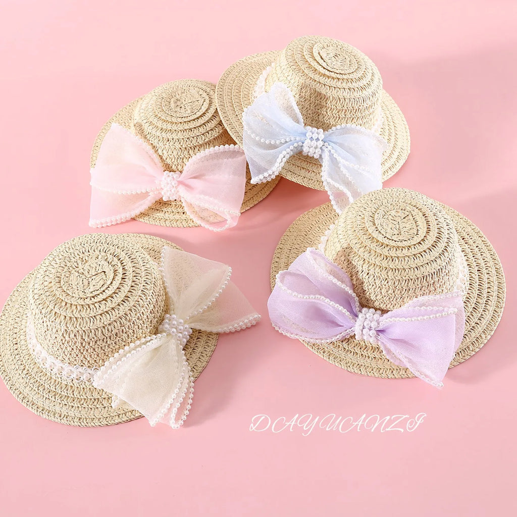 Pink pearl bow woven straw hat for a cat, shown in a princess style on a blank background.
