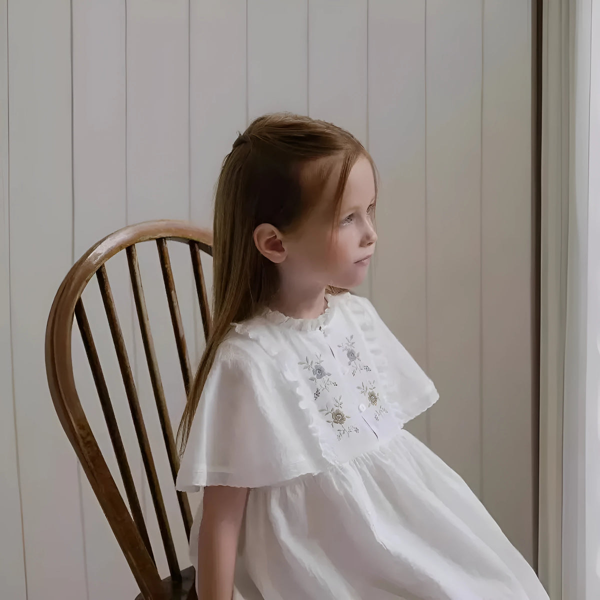 Girls white cotton summer dress with short ruffled sleeves and embroidered skirt detail