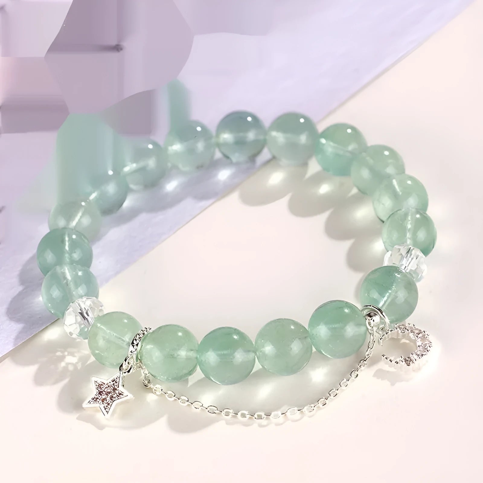 Green fluorite bracelet with star and moon princess designs on wrist