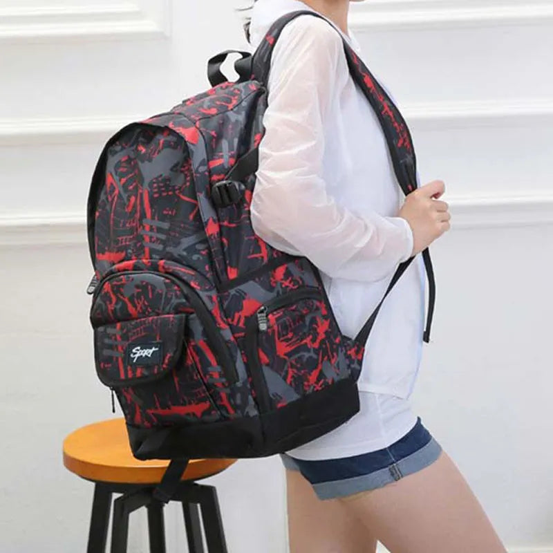 A classic blue or red nylon backpack with a large main compartment and multiple organiser pockets.