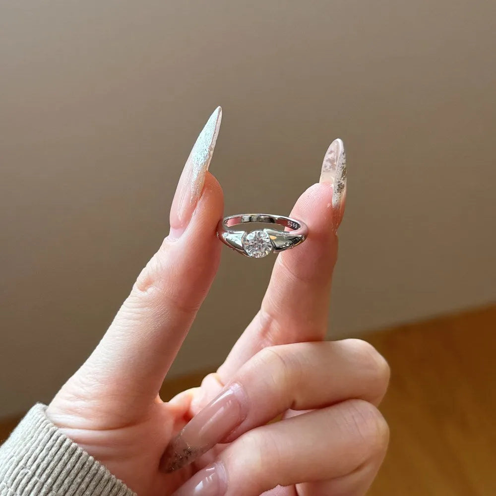 Silver round ring with glossy electroplated finish on display
