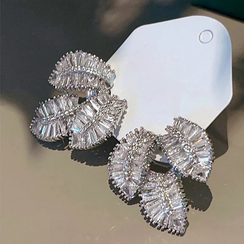 Leaf shaped zircon earrings in white gold colour with copper base and quadrilateral inlay
