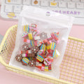 Assortment of 50 small colourful cartoon fruit and animal themed TPR rubber mini erasers.