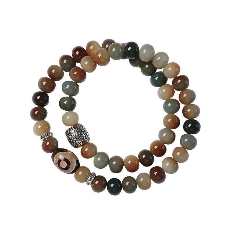 Dunhuang style bodhi seed double ring bracelet with detailed carving on an adjustable cord.
