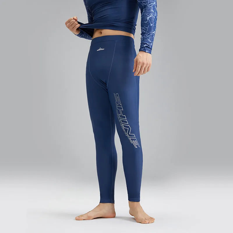 Men's dark blue patterned nylon swimwear set consisting of a top and trousers.