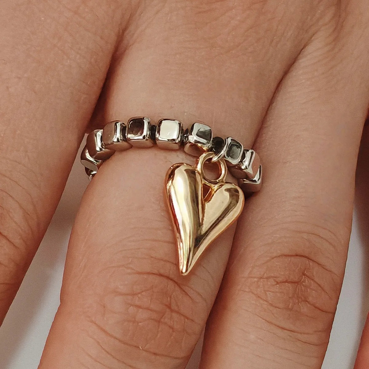 Handmade beaded elastic string love ring with geometric heart design in gold electroplated finish