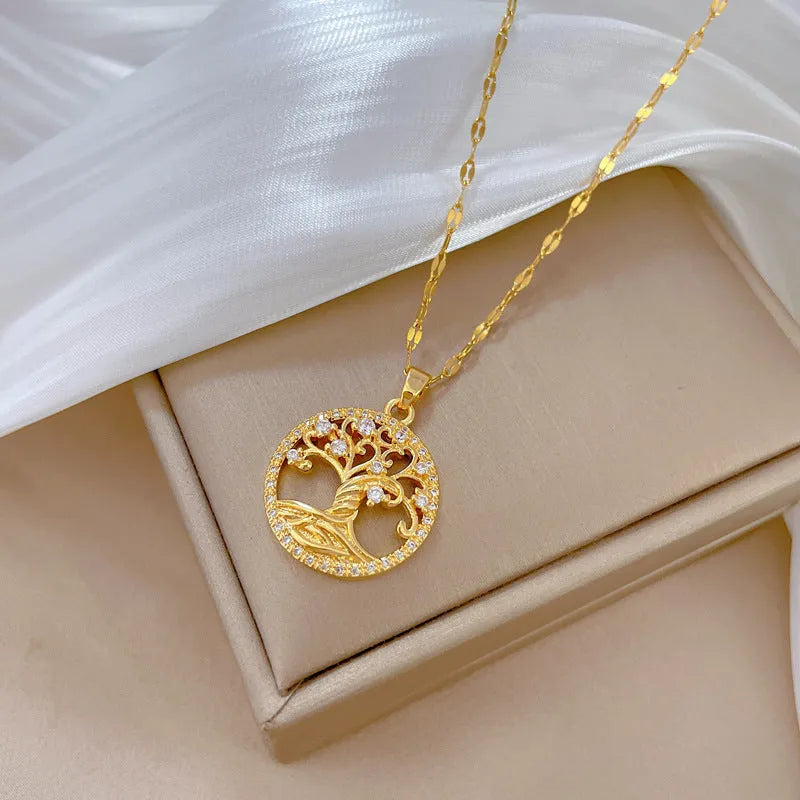 Gold-plated stainless steel necklace with mother-of-pearl and rhinestone pendant on a lip chain.