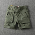 Men's cotton stretch cargo shorts in army green with multiple pockets on a white background.