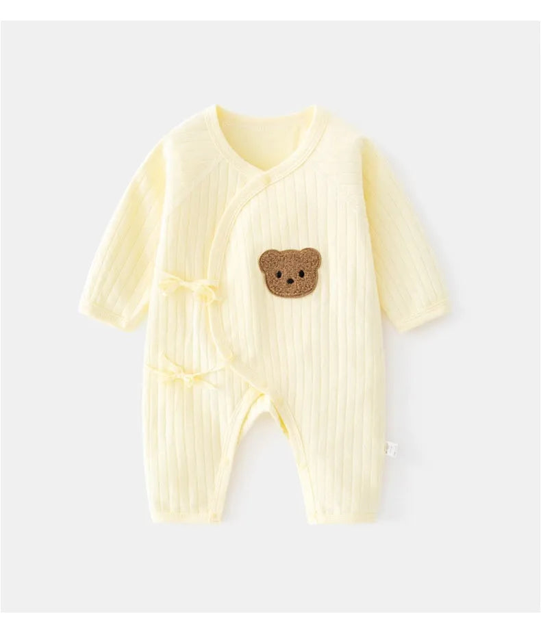 White cotton newborn jumpsuit with top fly lace closure and jacquard teddy bear straps