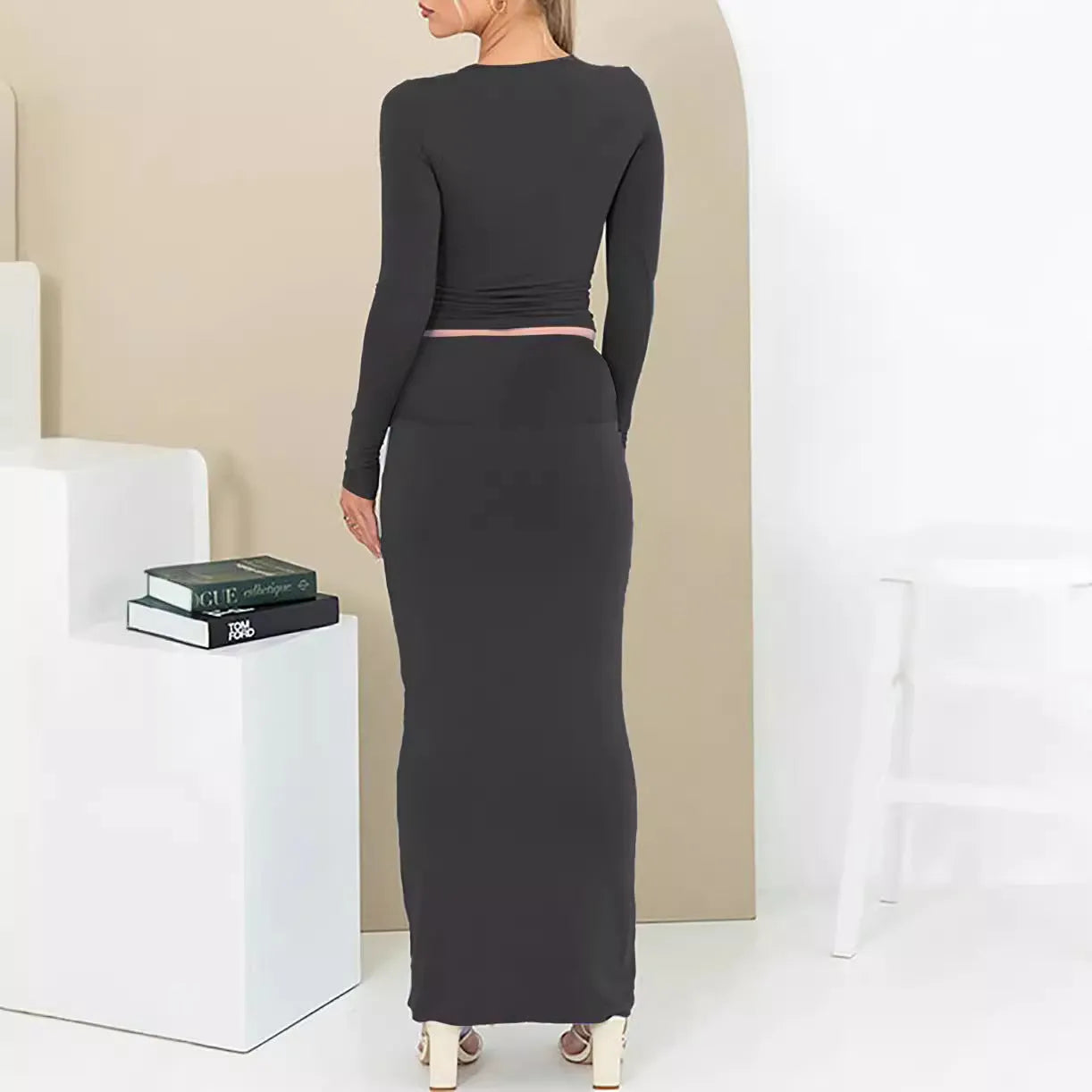 Women's black sweet style two-piece suit with three-quarter sleeve top and long skirt.