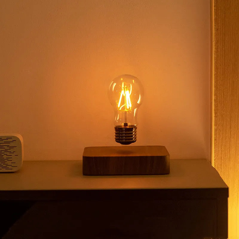 Self-rotating maglev bulb with warm yellow light, ABS base, 6cm diameter bulb, and 13.5cm diameter base.