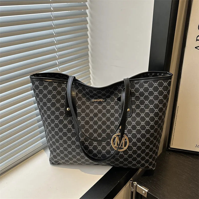 Black PU shoulder bag with sewing thread detail, showing interior polyester lining.