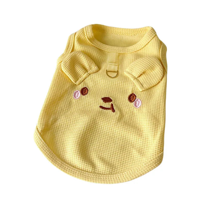 Yellow waffle weave polyester dog vest shown on a small dog, demonstrating its casual fit and textured fabric.