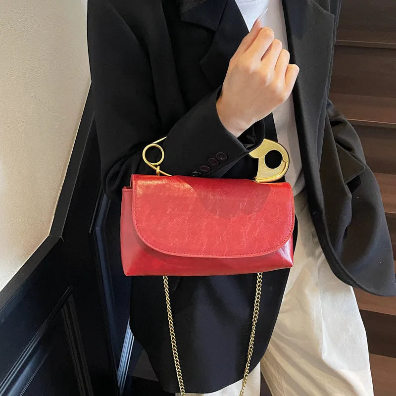 Creative Personality PU paper clip shoulder handbag in a horizontal square shape.
