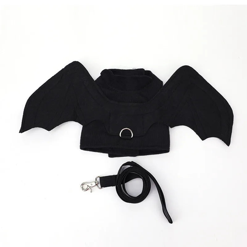 Black bat wing costume accessory for dogs showing chest and back attachment with optional traction rope