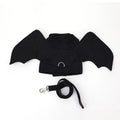 Black bat wing costume accessory for dogs showing chest and back attachment with optional traction rope