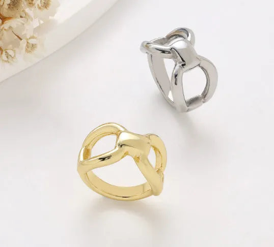Gold or steel colour titanium steel women's ring with hollow bow shape and butterfly geometric design.