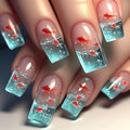 Mid-square blue glaze goldfish nail art pieces with armour design and jelly glue finish on a table