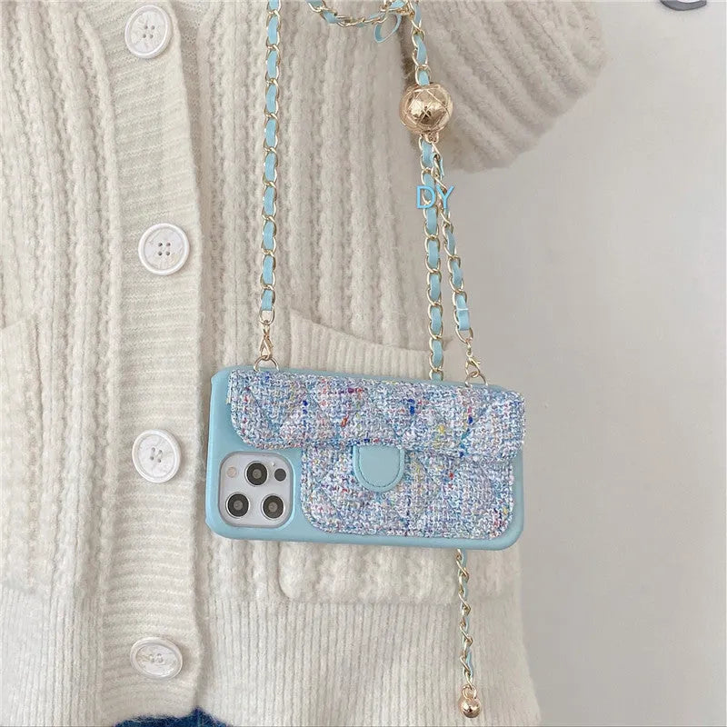 Imitation leather iPhone compatible phone case with long chain and golden ball detail in black, pink, yellow, or blue