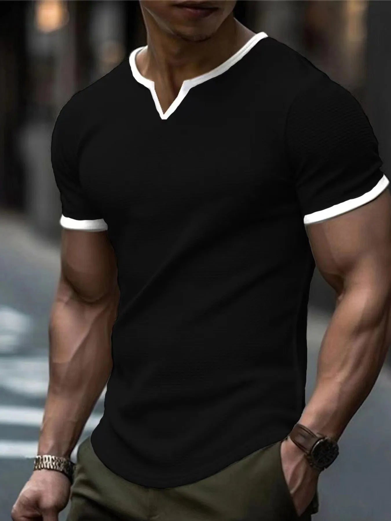 Man wearing a grey and white colour-block V-neck waffle knit short sleeve T-shirt.
