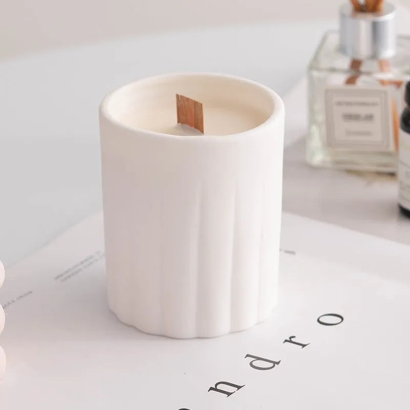 Ceramic candlestick with minimalist relief pattern on a dining table
