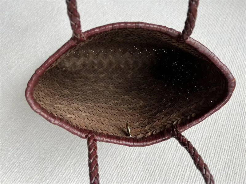 Brown handmade woven leather tote bag with a front pocket and polyester lining.