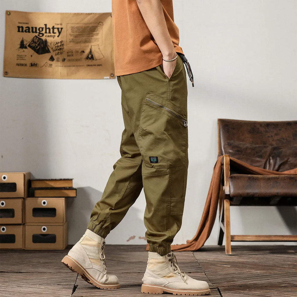 Men's cotton tapered harem trousers in black with elastic waistband and ankle band detailing