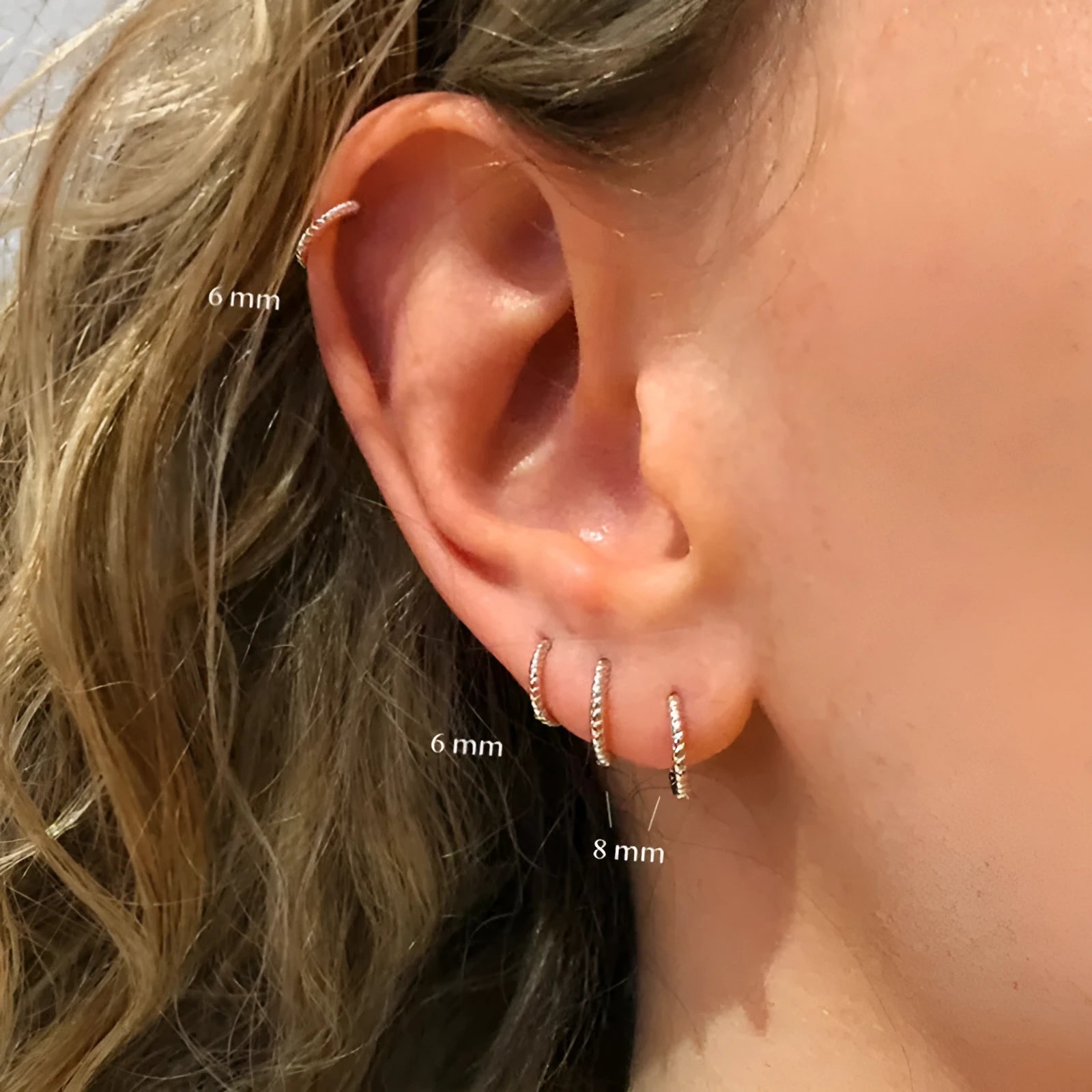 Sterling silver twisted round ring earrings in gold or white gold finish, shown in 6mm, 7mm, 8mm, and 13mm sizes.