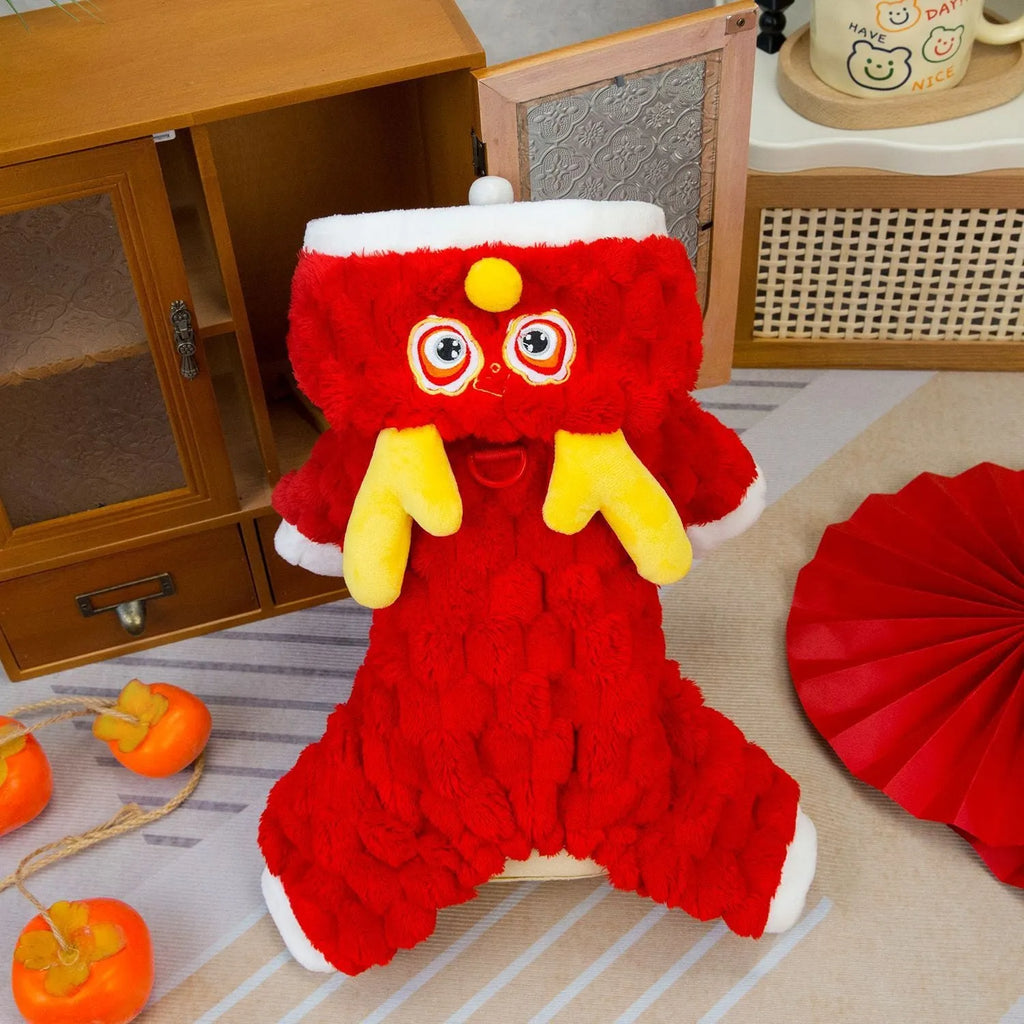Red velvet pet jacket with cartoon dragon design for dogs and cats on a hanger