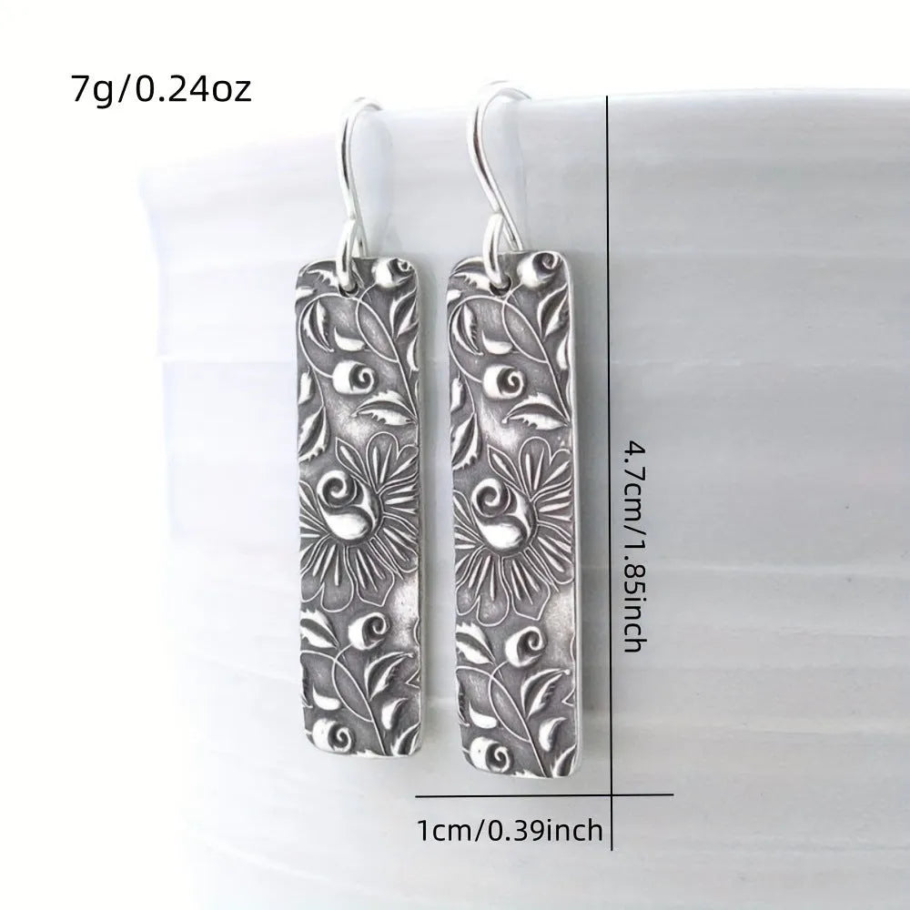 Silver geometric long earrings with a carved vine pattern in a retro style