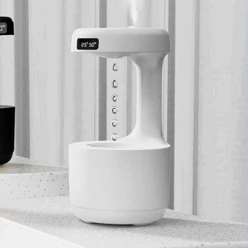Bedroom anti-gravity humidifier with clock and backflow aroma diffuser in white plastic on desk with LED display