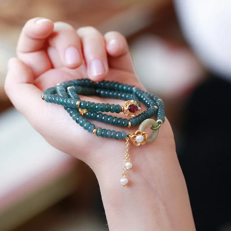Blue water abacus and jade bead bracelet with tourmaline pearls in a three-ring design.