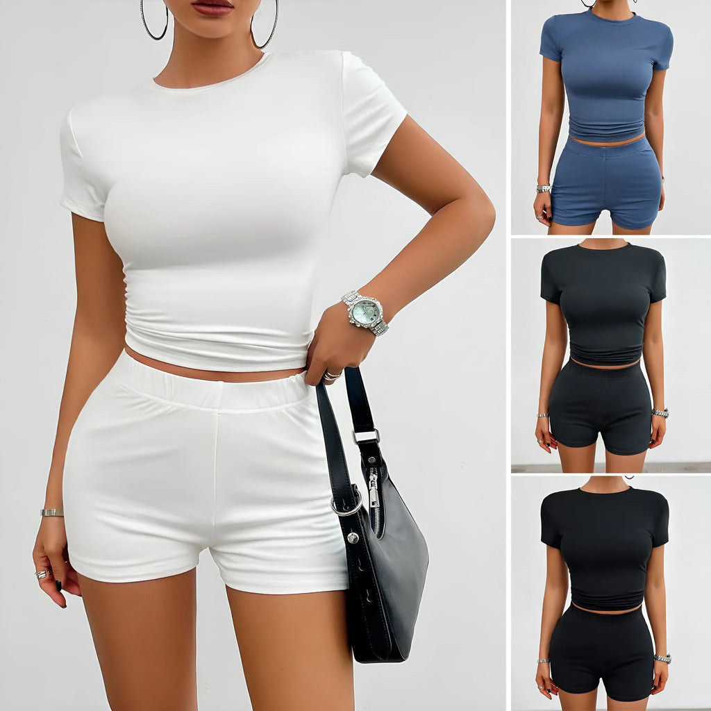 Women's solid colour slim-fit sports set with round-neck T-shirt and elastic shorts.