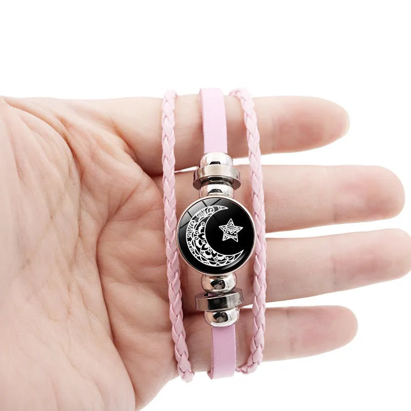 Luminous sun and moon couple leather bracelet on black background, showing glass pattern and adjustable chain