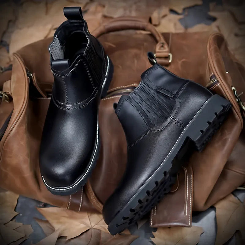 Men's round toe ankle boots in black with lace-up closure and rubber sole on outdoor ground