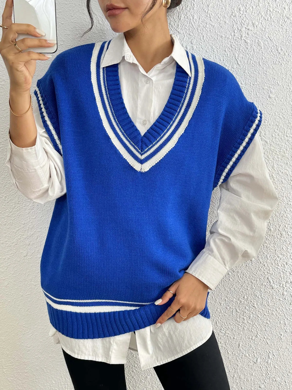 Women's loose-fit college style vest sweater in blue, coffee, and black colour options.