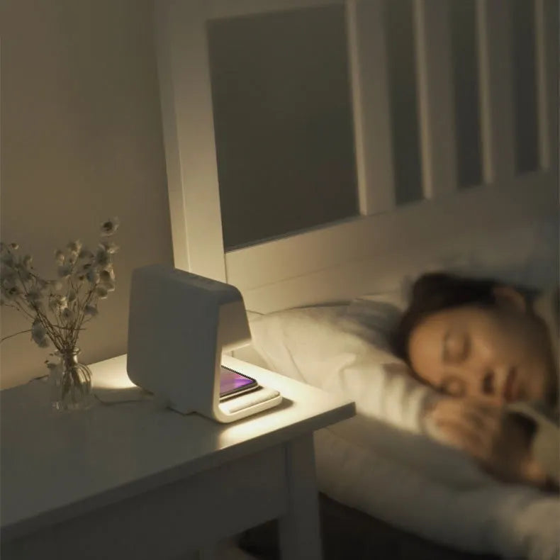 White 3-in-1 bedside lamp with wireless charging pad, LCD screen clock, and touch dimming.