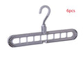 Plastic clothes hanger with a white hook on a pink background, showing its 33 cm length and rotatable handle.