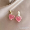 Blue and pink candy-style heart-shaped alloy stud earrings for women on a white background.