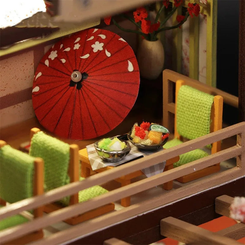 Assembled wooden Japanese sushi restaurant model with flash function, 21 by 32 by 5.5 centimetres, on a white background.