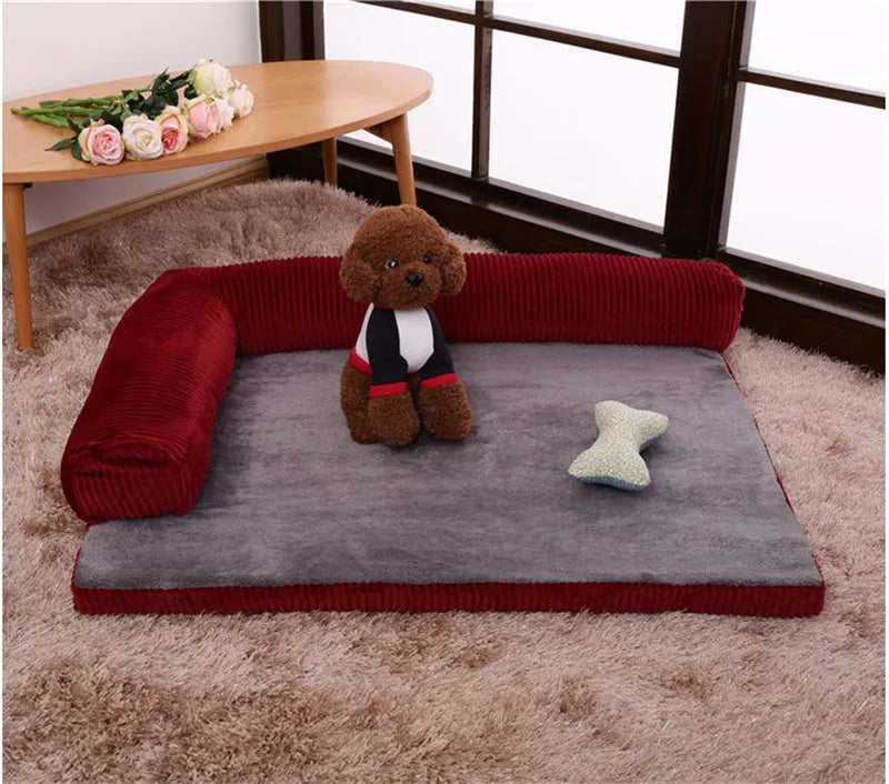 A large grey corduroy dog sofa bed with bilateral sides and a non-slip base on a wooden floor.