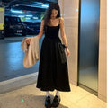 A-line slip dress in black with wide waist and sleeveless design made from polyester