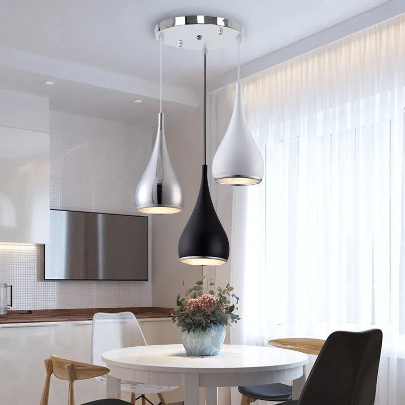 Modern minimalist iron chandelier with three light heads in a black finish, suspended from the ceiling.