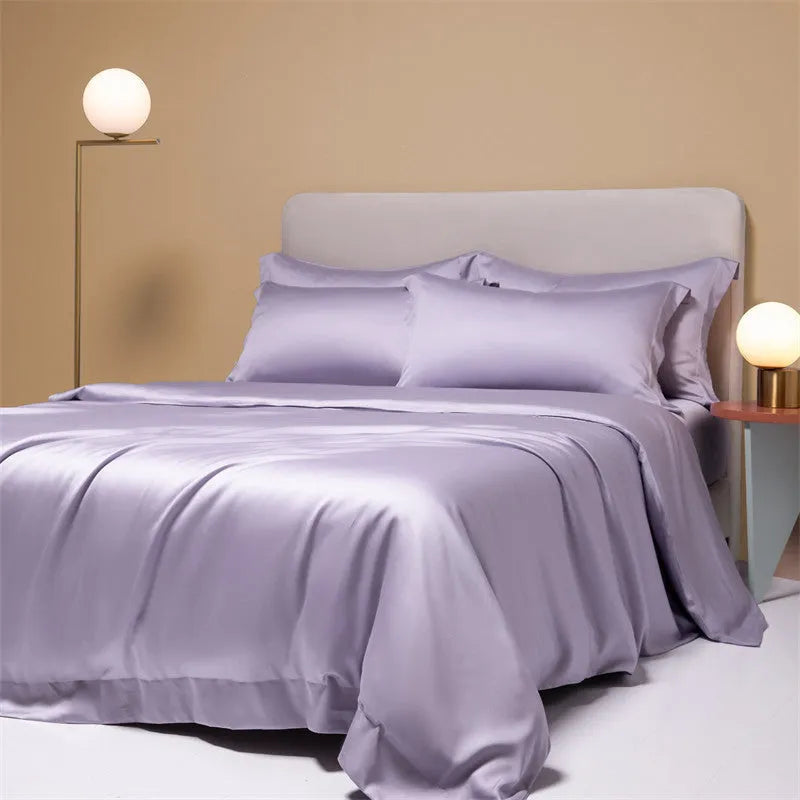 A modern Lenzing Tencel bedding set with a quilt cover and pillowcases in a neutral colour, laid flat on a bed.