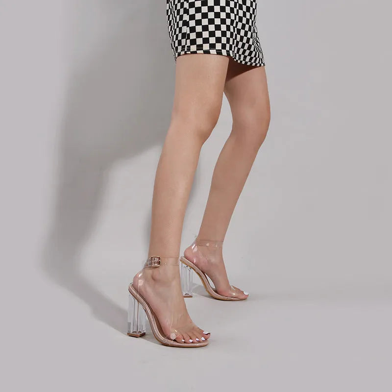 Apricot women's high heel sandals with a clear glass-style heel and a buckle fastening.