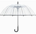 Long-handled transparent umbrella with black steel frame and white handle on a black background.