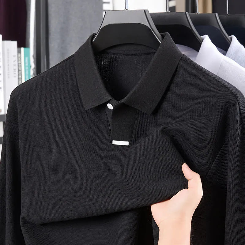 Men's grey loose-fit cotton polo shirt with a lapel collar and long sleeves laid flat.